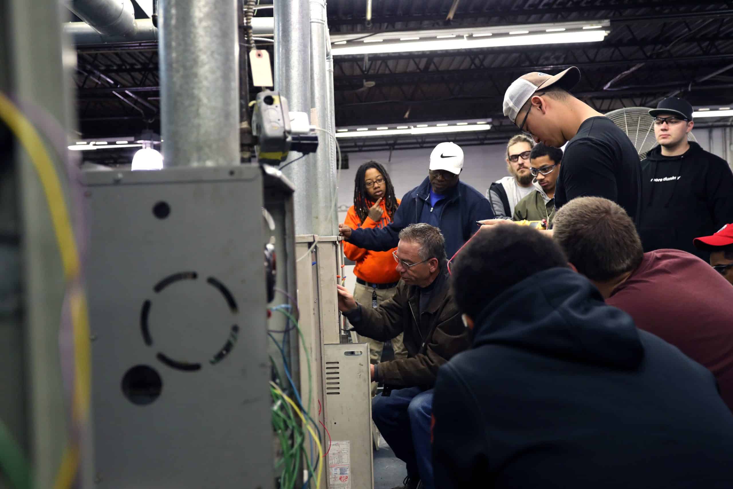 Plumbing Instructor Demonstrating Process to Students