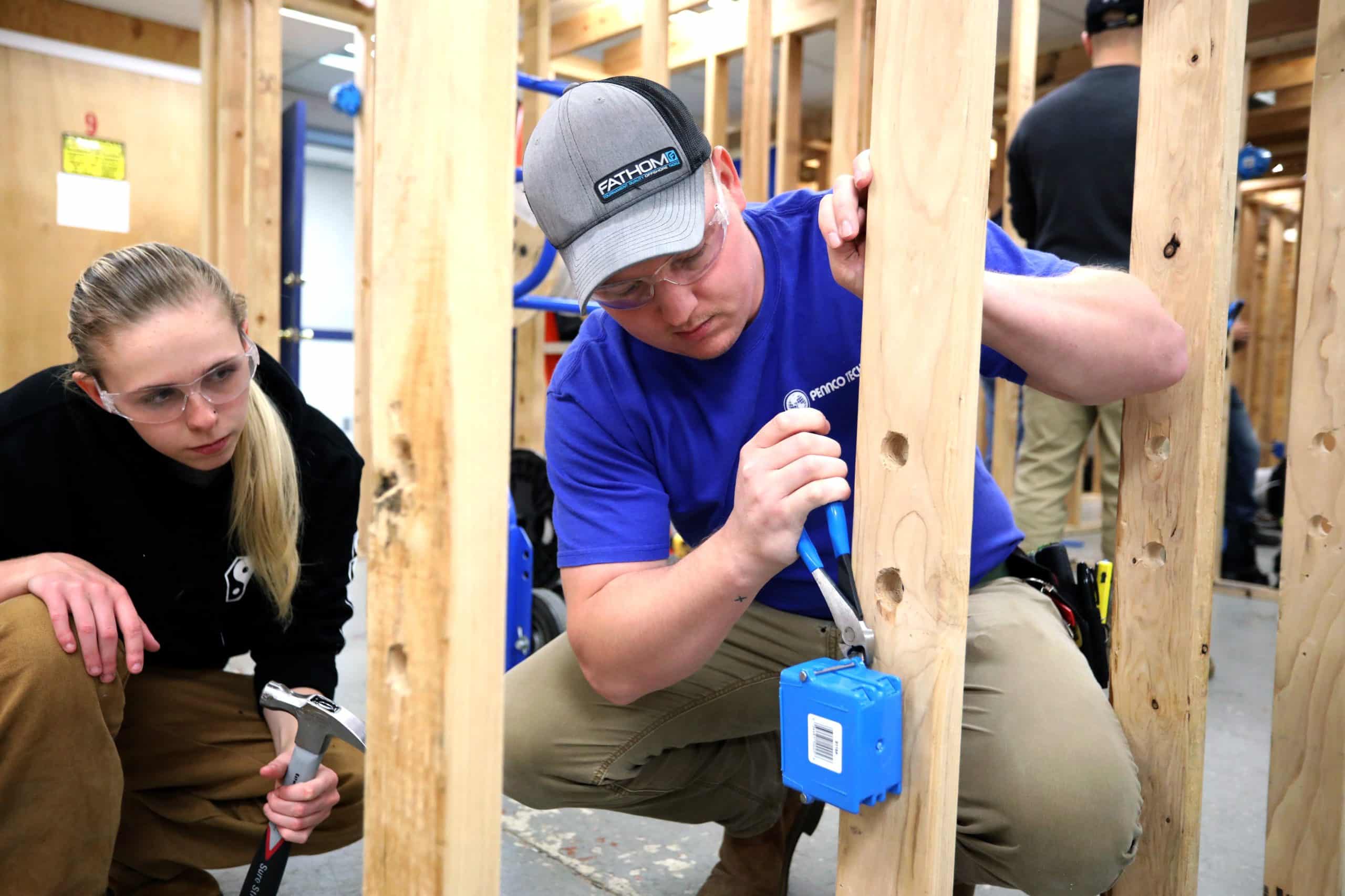Electrician Student Adjusting Component on Board
