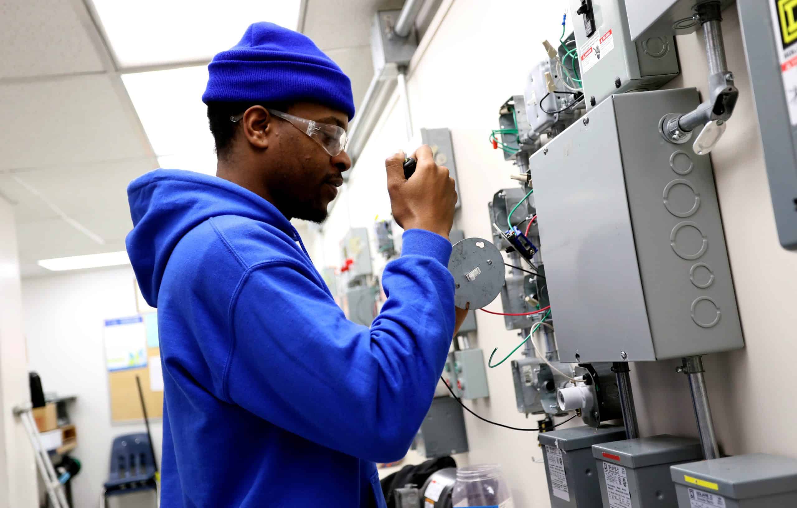 Electrician Student Working on Wires in Junction Box