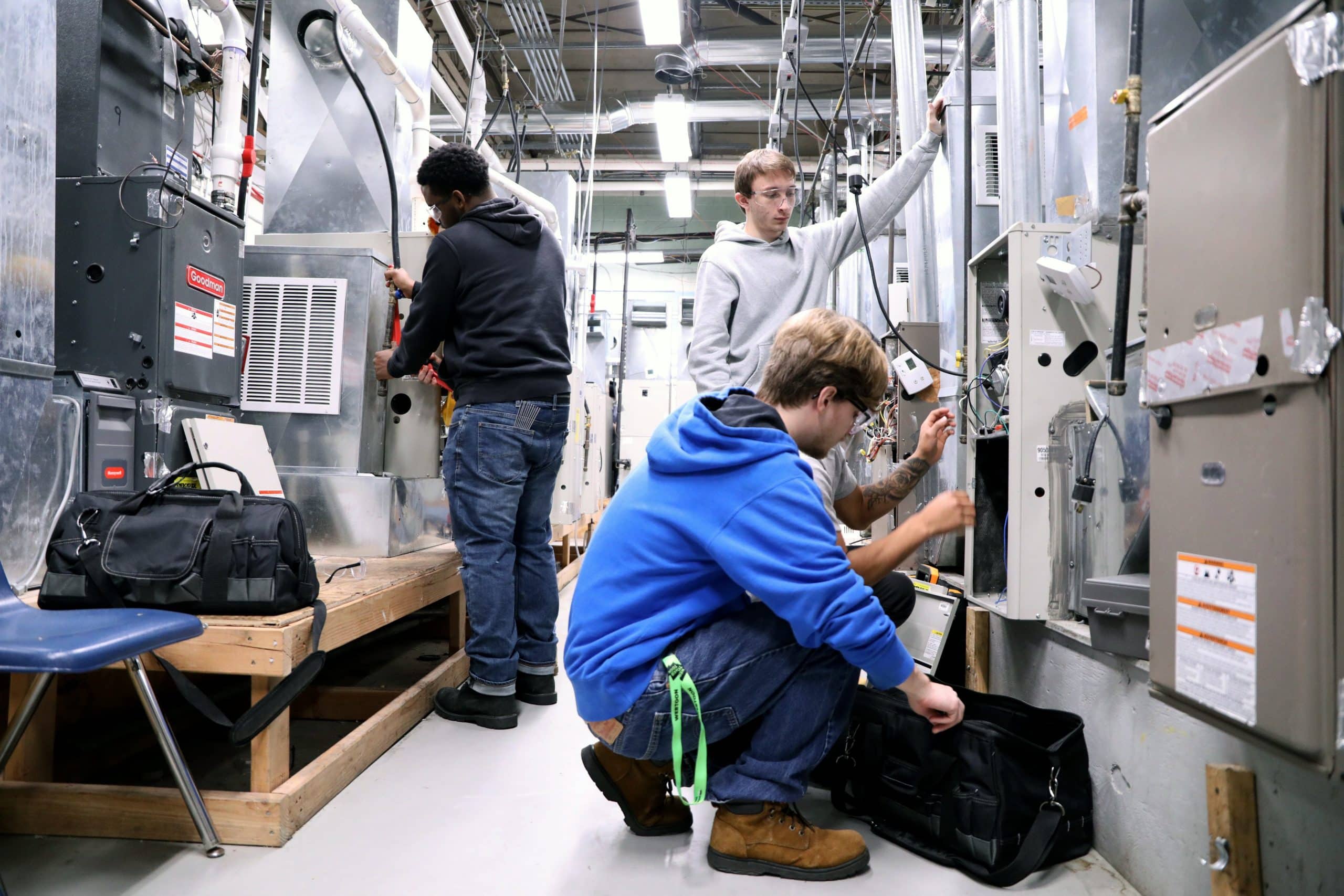 Heating and Air Conditioning Students Examining Units