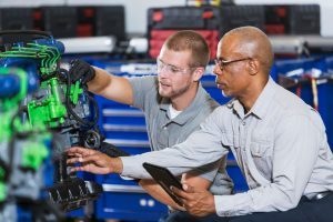Vocational school student learns to repair engine