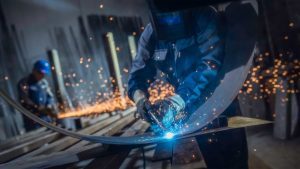 Industrial workers with welding tools