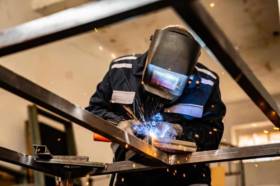 A metal brazer fabricating a frame 