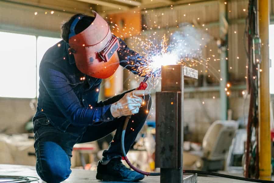 Welder working on project inside workshop