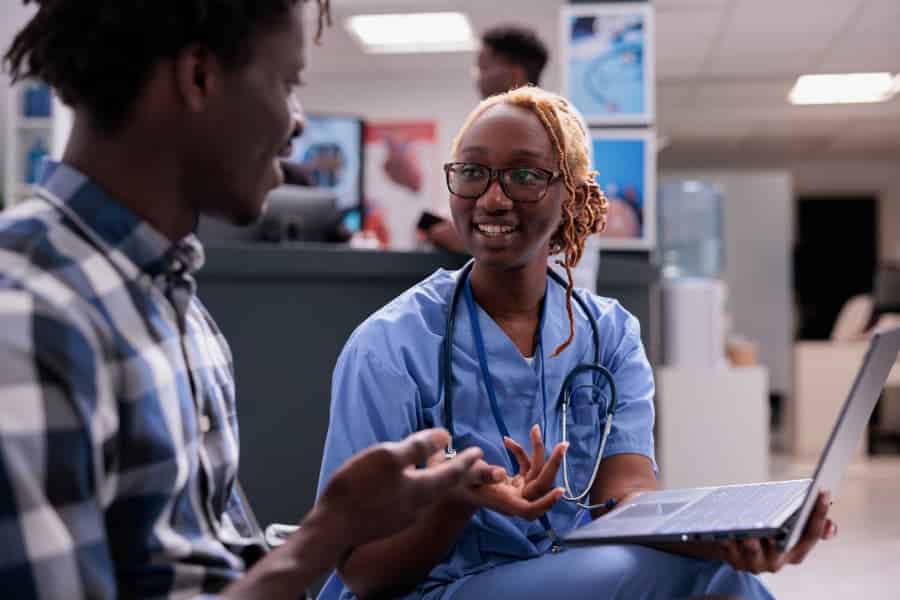 Medical assistant consults with patient