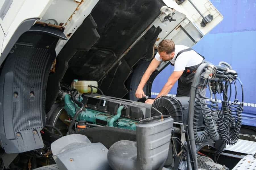 Diesel mechanic working on truck