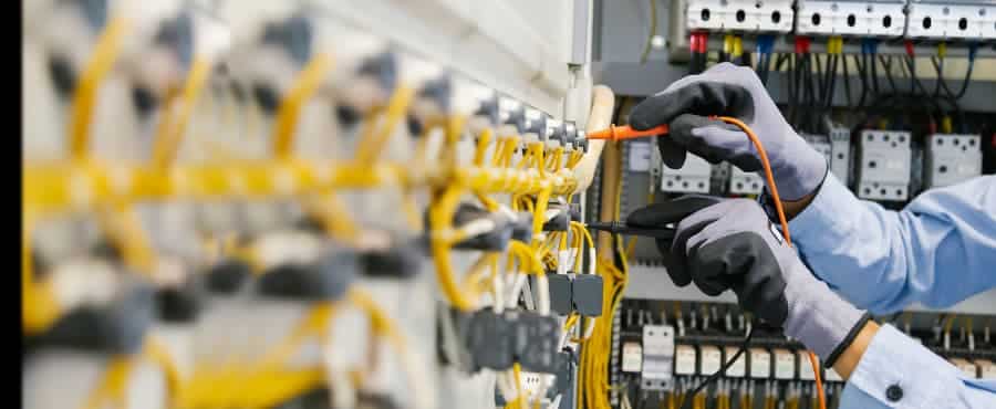 Electrician tests electrical installations and wiring on protective relays