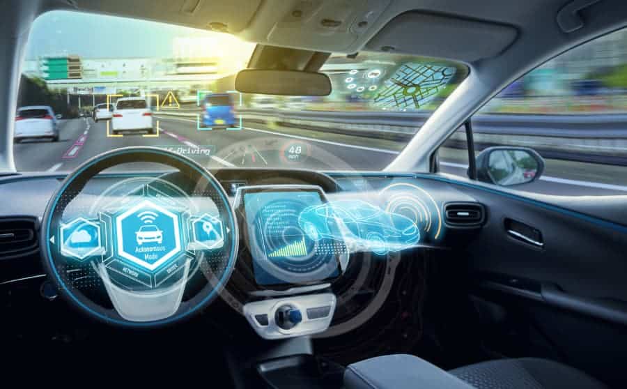 Empty cockpit of autonomous car with diagrams of digital speedometers, sensors, and more