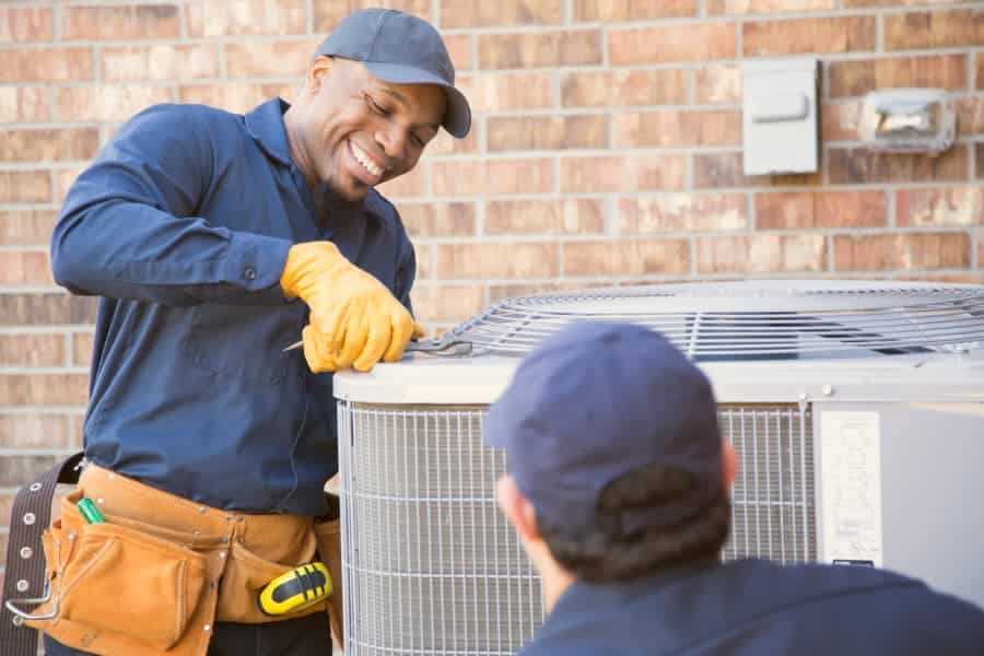 HVAC&R service techs performing repairs on residential HVAC system