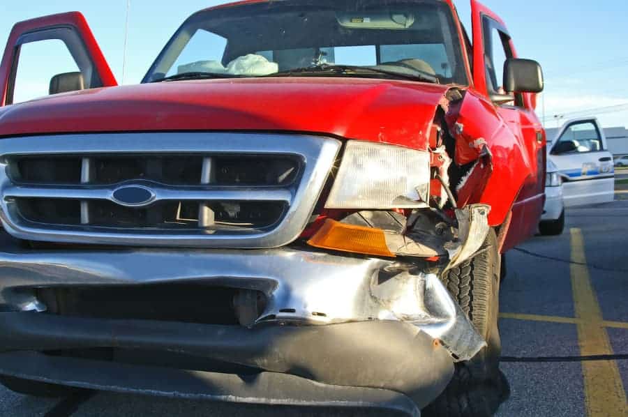 Red pickup truck with damage