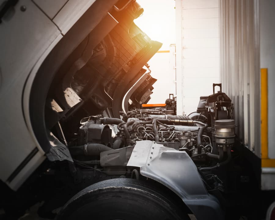 Truck with open hood revealing diesel engine