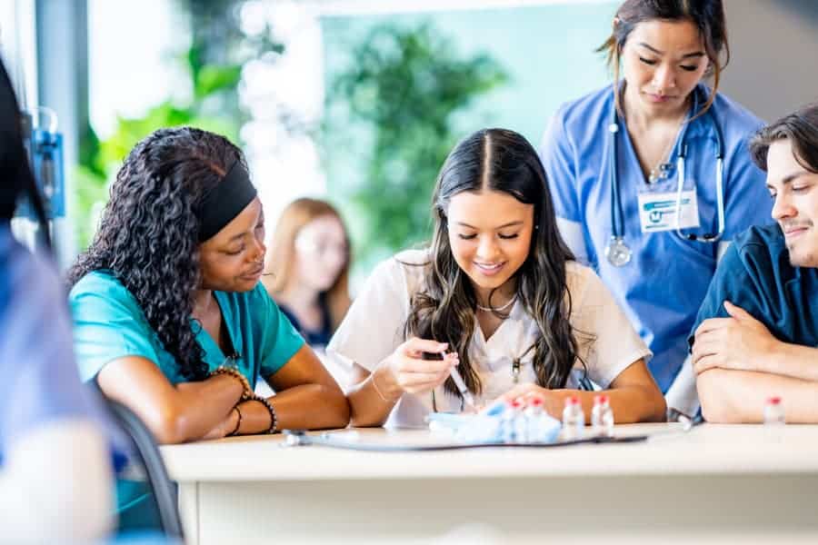 Medical assistant students training with syringe